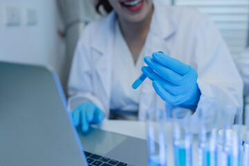 a female chemist is testing various liquid compounds in a lab, a scientist is doing research on the...