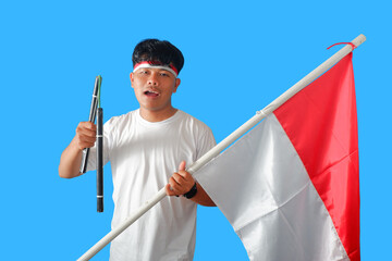 Young Man Holding Indonesian Flag and Traditional Weapon, Patriotic Expression