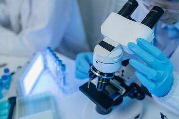 two scientists are working together to find a new antiviral drug, two chemists are using scientific...