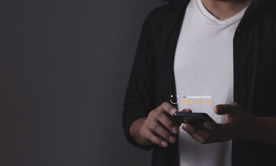 Review Customer, Young Man hand using smartphone mobile with five star to review and give 5 stars...