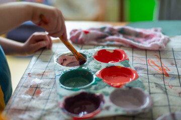 Childrens kids crafts palette colour paint mixing colourful hands