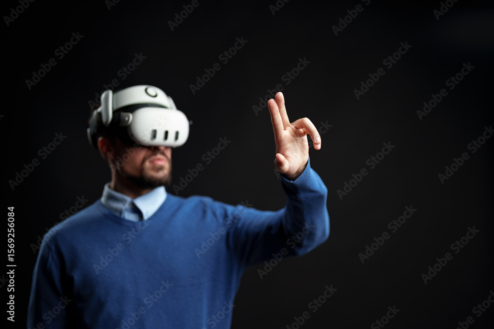 Poster person engaged in virtual reality experience while using motion controls indoors