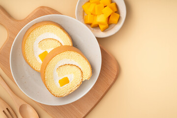 Delicious mango cream Swiss roll cake on plate