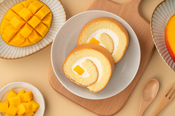 Delicious mango cream Swiss roll cake on plate