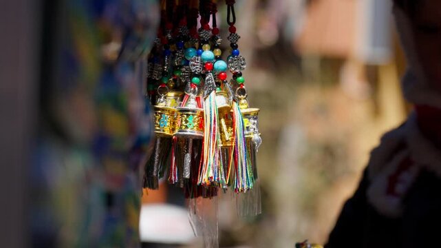A handcrafted miniature prayer wheel from Shangri-La, adorned with tassels and beads&mdash;symbolizing ethnic artistry, spiritual blessings, and local souvenir charm.