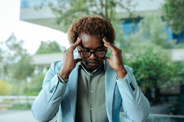 Worried professional businessman feeling stressed in a modern office