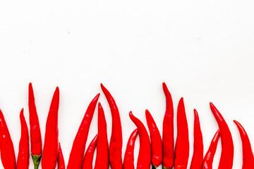 Cooking hot food with chilli pepper on white table background top view copy space