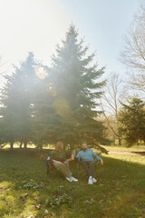 Fototapeta premium Couple enjoying a relaxing afternoon in outdoor folding chairs under sunshine