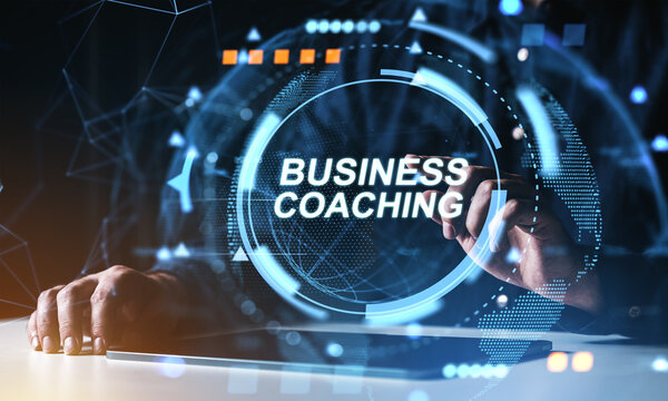 Futuristic business coaching concept with digital interface and hands interacting on tablet in modern virtual workspace environment.