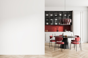 Modern kitchen dining area with red accents and blank white wall for poster or artwork mockup...