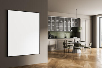 Blank poster mockup on modern kitchen interior wall with wooden floor and green accents in...