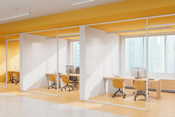 Modern open-space office interior with yellow chairs, wooden desks, and large windows in a bright...