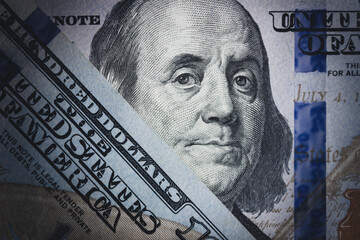 Close-up of US dollar bill featuring Benjamin Franklin.