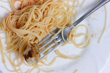 Spaghetti with meatball on a fork, inviting and delicious.