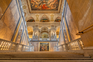 Grand museum staircase with marble and ceiling fresco
