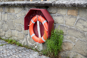 lifebuoy attached to a stone wall to rescue people