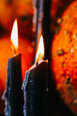  Witchcraft and magic attributes.Close-up of Black Candles with Pumpkins. October holiday...