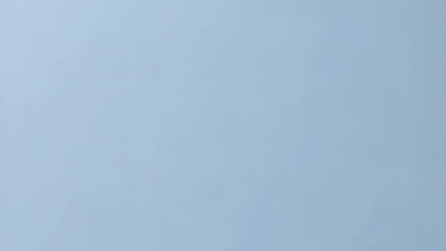 A head made of puzzle pieces with a blue and white color scheme. Concept of disarray and confusion, as the pieces are scattered and disorganized