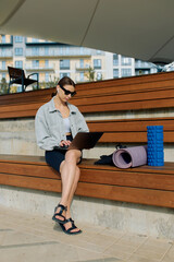 Young woman waiting for her yoga class in the morning