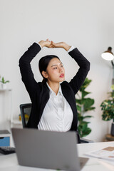 Asian Girl or business asian woman lying in workplace and work on laptop lazy weekend.