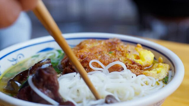 A bowl of Yunnan-style rice noodles topped with native chicken slices in clear broth&mdash;highlighting savory warmth, regional texture, and the wholesome charm of ethnic Chinese street cuisine.