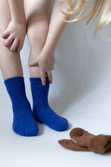 Baby feet in blue socks on a white background