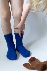 Baby feet in blue socks on a white background