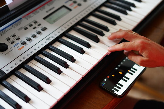 Man plays digital and smartphone piano simultaneously