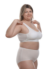 Obraz premium Weight loss. Plus size woman in underwear on white background