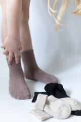 Baby feet in warm brown socks on a white background