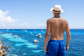 Man enjoying sea view from coastal cliff in Favignana, Sicily