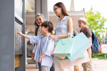 Asian multigenerational family shopping at shopping mall, mother child and grandmother checking screen, enjoying weekend activity holiday trip planning, family lifestyle, shopping cashback promotion