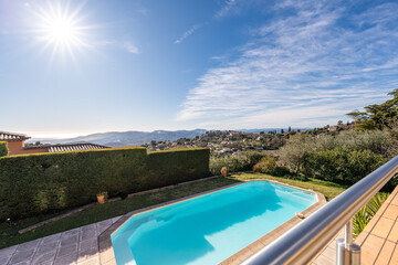Sunny panoramic view of luxury private pool and Mediterranean landscape — real estate, travel,...