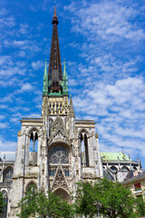 Gothic architecture of Rouen Cathedral showcases intricate details under a bright blue sky