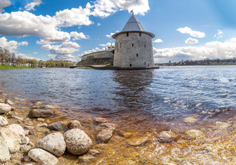 Ploskaya Tower of Pskov Kremlin at Pskova River's mouth, with fortress walls visible across...