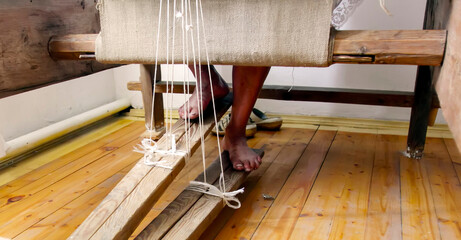 Crafting textiles with traditional loom technique inside a vibrant workshop in the heart of a cultural village