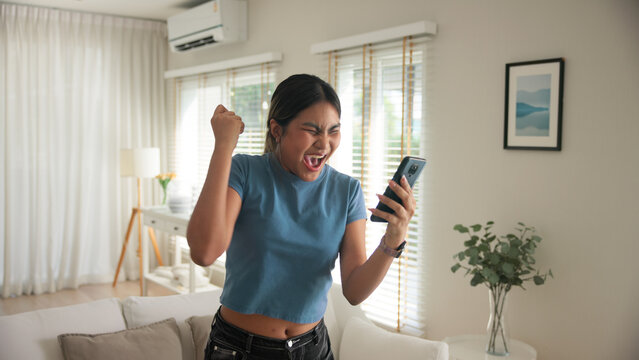 Asia young adult black people humor bizarre funny dance good news at home living room happy joy job hired interview result on mobile, award bonus, win luck bet online game order trade, loan money.