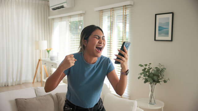 Asia young adult black people humor bizarre funny dance good news at home living room happy joy job hired interview result on mobile, award bonus, win luck bet online game order trade, loan money.