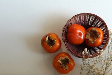 Persimmon on the table, free space, fruits and berries, background, healthy food