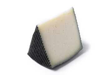 Close-up of a wedge of semi-cured cow's cheese isolated on white background.