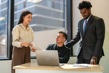 Diverse business team brainstorming together, strategic planning with laptop in office, inclusive...
