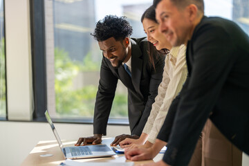 Diverse business team brainstorming together, strategic planning with laptop in office, inclusive...