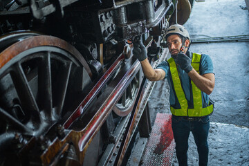 man in a safety vest is working on a train engine