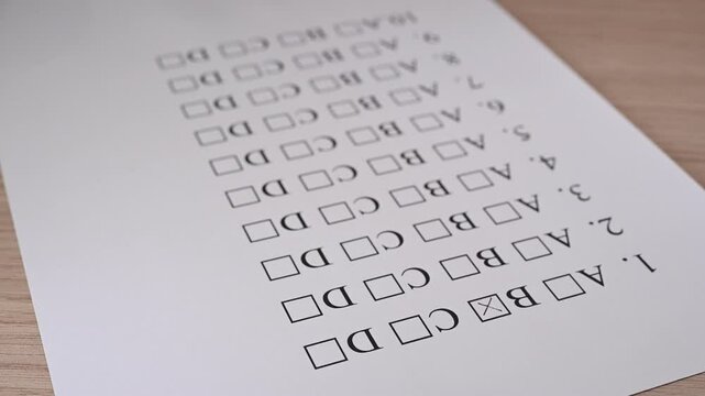 Complete the multiple choice test a b c d, close up of a piece of paper and marked answers