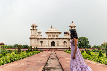 Tourist taking selfie in front of Itmad-Ud-Daulah's Tomb in Agra, India