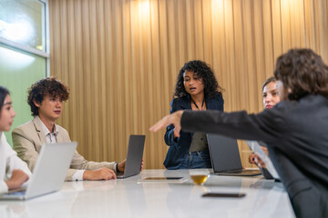 Diverse business team brainstorming together, strategic planning with laptop in office, inclusive...