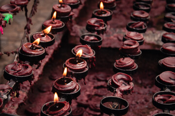 Rows of lit candles for prayer offering in traditional Catholic devotees in the Philippines during...