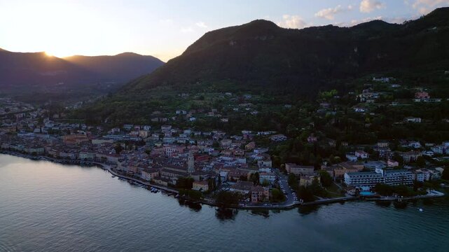 Europe, Italy, Brescia , Garda lake , Salo' drone aerial view of village with church and lake with blue water - Italian Republic from 1943 to 1945 during the reign of Benito Mussolini fascist