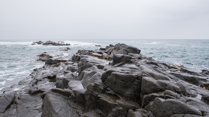 Seascape image taken on the South African coastline with rocks in foreground