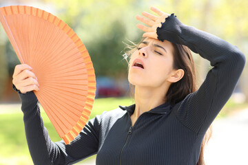 Woman fanning in the street during heat stroke